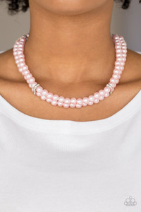 Pinched between white rhinestone encrusted frames, strands of classic pink pearls layer below the collar for a timeless look. Features an adjustable clasp closure.

Sold as one individual necklace. Includes one pair of matching earrings.