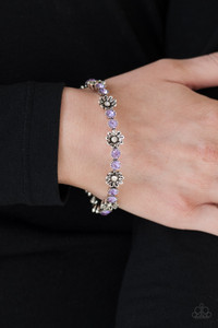 Dotted with white rhinestone centers, dainty silver flowers join with pairs of glittery purple rhinestones around the wrist, creating a whimsical bangle.
Sold as one individual bracelet. Dotted with white rhinestone centers, dainty silver flowers join with pairs of glittery purple rhinestones around the wrist, creating a whimsical bangle.
Sold as one individual bracelet.