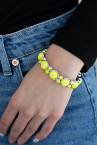 Clustered yellow beaded frames are threaded along stretchy bands around the wrist, creating a bubbly look.
Sold as one individual. Clustered yellow beaded frames are threaded along stretchy bands around the wrist, creating a bubbly look.
Sold as one individual.