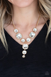Featuring sleek gold frames, a dramatic collection of white gems cascade from the bottom of a thick gold chain. Additional gems trickle from the center, creating a glamorous extended pendant below the collar. Features an adjustable clasp closure.
Sold as one individual necklace. Includes one pair of matching earrings. Featuring sleek gold frames, a dramatic collection of white gems cascade from the bottom of a thick gold chain. Additional gems trickle from the center, creating a glamorous extended pendant below the collar. Features an adjustable clasp closure.
Sold as one individual necklace. Includes one pair of matching earrings.