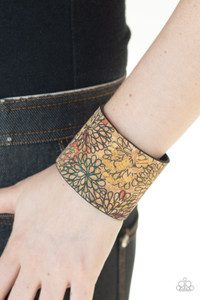 Painted in a colorfully distressed floral pattern, a thick cork-like leather band wraps around the wrist for a statement-making look. Features an adjustable snap closure. Painted in a colorfully distressed floral pattern, a thick cork-like leather band wraps around the wrist for a statement-making look. Features an adjustable snap closure.
