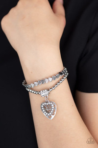 Brushed in an antiqued finish, classic silver beads and dainty silver heart beads are threaded along stretchy bands around the wrist, creating an adorable duo. Infused with a white rhinestone encrusted fitting, a white rhinestone encrusted heart frame and airy silver heart charm swings from the wrist for a whimsical finish.
Sold as one pair of bracelets. Brushed in an antiqued finish, classic silver beads and dainty silver heart beads are threaded along stretchy bands around the wrist, creating an adorable duo. Infused with a white rhinestone encrusted fitting, a white rhinestone encrusted heart frame and airy silver heart charm swings from the wrist for a whimsical finish.
Sold as one pair of bracelets.
