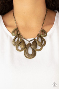 Hammered in an antiqued textured finish, pairs of mismatched brass teardrops gradually increase in size as they drip below the collar, creating a statement-making fringe. Features an adjustable clasp closure.
Sold as one individual necklace. Includes one pair of matching earrings. Hammered in an antiqued textured finish, pairs of mismatched brass teardrops gradually increase in size as they drip below the collar, creating a statement-making fringe. Features an adjustable clasp closure.
Sold as one individual necklace. Includes one pair of matching earrings.