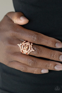 Dotted in glassy peach rhinestones, dainty shiny copper bands and flirty heart-shaped shiny copper frames weave around a timeless peach rhinestone center, creating a regally layered centerpiece atop the finger. Features a stretchy band for a flexible fit.

Sold as one individual ring.