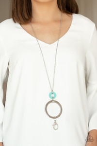 Featuring a delicately hammered finish, a large silver hoop links swings from the bottom of a refreshing turquoise stone ring at the end of a lengthened silver chain for a sophisticated look. A lobster clasp hangs from the bottom of the design to allow a name badge or other item to be attached. Features an adjustable clasp closure.

Sold as one individual necklace. Includes one pair of matching earrings.