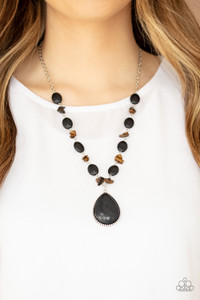 Earthy black stones join bits of tiger's eye rock along a silver chain below the collar. Featuring a studded silver frame, an oversized black teardrop stone pendant swings from the center for a statement-making finish. Features an adjustable clasp closure.
Sold as one individual necklace. Includes one pair of matching earrings. Earthy black stones join bits of tiger's eye rock along a silver chain below the collar. Featuring a studded silver frame, an oversized black teardrop stone pendant swings from the center for a statement-making finish. Features an adjustable clasp closure.
Sold as one individual necklace. Includes one pair of matching earrings.