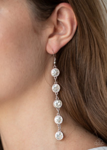 Encased in sleek silver fittings, a dramatic row of oversized white rhinestones delicately link in an elongated lure for a glamorous look. Earring attaches to a standard fishhook fitting.

Sold as one pair of earrings.