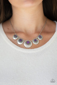 Dotted with glassy purple stone centers, silver sunburst studded frames link below the collar, creating a colorful fringe. Features an adjustable clasp closure.
Sold as one individual necklace. Includes one pair of matching earrings. Dotted with glassy purple stone centers, silver sunburst studded frames link below the collar, creating a colorful fringe. Features an adjustable clasp closure.
Sold as one individual necklace. Includes one pair of matching earrings.