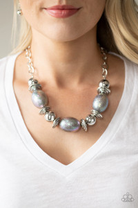 Attached to a textured silver chain, a glamorous collection of oversized silver beads and iridescent oval shaped beads are threaded along a stretchy band below the collar for a gorgeous effect. The iridescent beads feature a subtle scratch surface, adding shimmer to the refined display. Features an adjustable clasp closure.
Sold as one individual necklace. Includes one pair of matching earrings. Attached to a textured silver chain, a glamorous collection of oversized silver beads and iridescent oval shaped beads are threaded along a stretchy band below the collar for a gorgeous effect. The iridescent beads feature a subtle scratch surface, adding shimmer to the refined display. Features an adjustable clasp closure.
Sold as one individual necklace. Includes one pair of matching earrings.