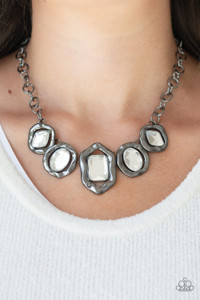 Featuring imperfect gunmetal frames, a collection of diamond, oval, and emerald-cut white rhinestones connect below the collar in a blinding fashion. Features an adjustable clasp closure.

Sold as one individual necklace. Includes one pair of matching earrings.