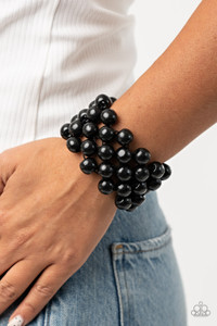 An oversized collection of black wooden beads are threaded along stretchy bands that ornately weave across the wrist, creating a decorative summery pattern.
Sold as one individual bracelet. An oversized collection of black wooden beads are threaded along stretchy bands that ornately weave across the wrist, creating a decorative summery pattern.
Sold as one individual bracelet.