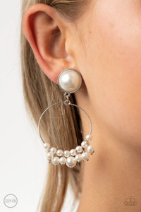 Featuring a pearl dotted fringe, a dainty silver wire hoop swings from the bottom of a matching pearl dotted fitting for a refined flair. Earring attaches to a standard clip-on fitting.
Sold as one pair of clip-on earrings. Featuring a pearl dotted fringe, a dainty silver wire hoop swings from the bottom of a matching pearl dotted fitting for a refined flair. Earring attaches to a standard clip-on fitting.
Sold as one pair of clip-on earrings.