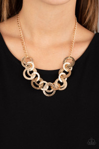 Brushed in a high-sheen shimmer, delicately hammered gold discs connect below the collar for a bold industrial look. Features an adjustable clasp closure.
Sold as one individual necklace. Includes one pair of matching earrings. Brushed in a high-sheen shimmer, delicately hammered gold discs connect below the collar for a bold industrial look. Features an adjustable clasp closure.
Sold as one individual necklace. Includes one pair of matching earrings.