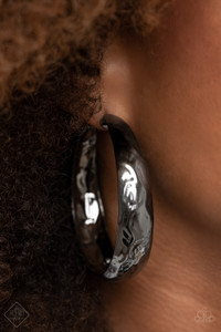 Hammered in blinding shimmer, a thick gunmetal hoop curls into a gritty-glamorous display with an exaggerated attitude. Earring attaches to a standard post fitting. Hoop measures approximately 2 1/2"" in diameter.

Sold as one pair of hoop earrings.