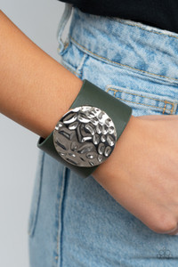A dramatically hammered silver disc is studded in place across the center of a thick green leather band, creating a colorfully rustic centerpiece around the wrist. Features an adjustable snap closure.
Sold as one individual bracelet. A dramatically hammered silver disc is studded in place across the center of a thick green leather band, creating a colorfully rustic centerpiece around the wrist. Features an adjustable snap closure.
Sold as one individual bracelet.