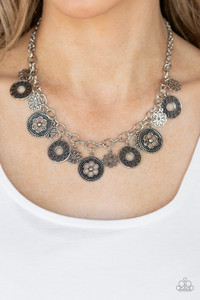 A collection of antiqued floral charms dangles from a thick silver chain, creating a whimsical fringe below the collar. Features an adjustable clasp closure.
Sold as one individual necklace. Includes one pair of matching earrings. A collection of antiqued floral charms dangles from a thick silver chain, creating a whimsical fringe below the collar. Features an adjustable clasp closure.
Sold as one individual necklace. Includes one pair of matching earrings.