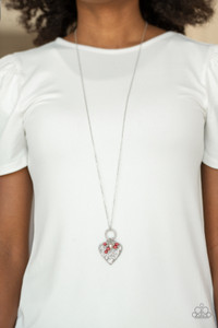 Infused with dainty red pearls and a shimmery silver heart charm, a stenciled silver heart pendant swings from the bottom of a lengthened silver chain for a whimsical look. Features an adjustable clasp closure.

Sold as one individual necklace. Includes one pair of matching earrings.