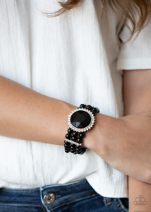 Threaded along stretchy bands, strands of polished black beads are held in place with white rhinestone encrusted fittings around the wrist. Bedazzled in a ring of glassy white rhinestones, a dramatically oversized black gem adorns the center for a speechless finish.
Sold as one individual bracelet. Threaded along stretchy bands, strands of polished black beads are held in place with white rhinestone encrusted fittings around the wrist. Bedazzled in a ring of glassy white rhinestones, a dramatically oversized black gem adorns the center for a speechless finish.
Sold as one individual bracelet.