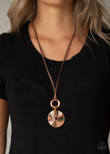Brushed in an antiqued finish, a hammered copper disc is knotted in place at the bottom of a hammered copper ring, creating a rustic pendant at the bottom of a skinny piece of brown leather. Features an adjustable sliding knot closure.
Sold as one individual necklace. Includes one pair of matching earrings. Brushed in an antiqued finish, a hammered copper disc is knotted in place at the bottom of a hammered copper ring, creating a rustic pendant at the bottom of a skinny piece of brown leather. Features an adjustable sliding knot closure.
Sold as one individual necklace. Includes one pair of matching earrings.