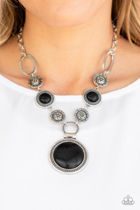Featuring floral, textured, and earthy black stone accents, a collection of unique silver frames link below the collar for a seasonal flair. A dramatically oversized black stone pendant dangles from the bottom for an eye-catching finish. Features an adjustable clasp closure.
Sold as one individual necklace. Includes one pair of matching earrings. Featuring floral, textured, and earthy black stone accents, a collection of unique silver frames link below the collar for a seasonal flair. A dramatically oversized black stone pendant dangles from the bottom for an eye-catching finish. Features an adjustable clasp closure.
Sold as one individual necklace. Includes one pair of matching earrings.