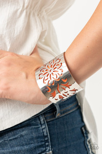 A thick piece of orange leather peeks out beneath an airy floral pattern stenciled into a thick silver cuff, creating a whimsical display around the wrist.
Sold as one individual bracelet. A thick piece of orange leather peeks out beneath an airy floral pattern stenciled into a thick silver cuff, creating a whimsical display around the wrist.
Sold as one individual bracelet.