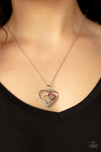 A red rhinestone encrusted heart intertwines with a plain silver heart inside of a larger silver heart frame, creating a romantic pendant at the bottom of a shimmery silver chain. Features an adjustable clasp closure.
Sold as one individual necklace. Includes one pair of matching earrings. A red rhinestone encrusted heart intertwines with a plain silver heart inside of a larger silver heart frame, creating a romantic pendant at the bottom of a shimmery silver chain. Features an adjustable clasp closure.
Sold as one individual necklace. Includes one pair of matching earrings.