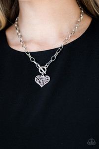 A filigree filled silver heart pendant swings from the bottom of an antiqued silver chain below the collar for a vintage inspired look. Features a toggle closure.
Sold as one individual necklace. Includes one pair of matching earrings. A filigree filled silver heart pendant swings from the bottom of an antiqued silver chain below the collar for a vintage inspired look. Features a toggle closure.
Sold as one individual necklace. Includes one pair of matching earrings.