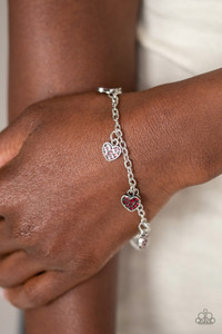 Encrusted in glassy pink and red rhinestones, dainty silver heart charms dangle from the wrist, creating a flirtatious sparkle. Features an adjustable clasp closure. Sold as one individual bracelet. Encrusted in glassy pink and red rhinestones, dainty silver heart charms dangle from the wrist, creating a flirtatious sparkle. Features an adjustable clasp closure. Sold as one individual bracelet.