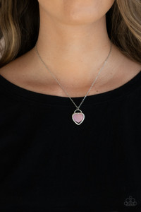 Featuring a pink cat's eye stone center, a glistening silver locket inspired frame glides along a dainty silver chain below the collar for a charming look. Sections of dainty white rhinestones dot the silver heart frame, adding flirty hints of shimmer. Features an adjustable clasp closure.
Sold as one individual necklace. Includes one pair of matching earrings. Featuring a pink cat's eye stone center, a glistening silver locket inspired frame glides along a dainty silver chain below the collar for a charming look. Sections of dainty white rhinestones dot the silver heart frame, adding flirty hints of shimmer. Features an adjustable clasp closure.
Sold as one individual necklace. Includes one pair of matching earrings.