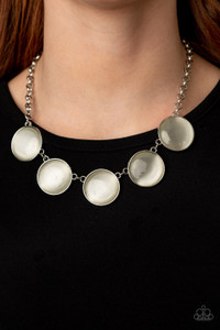 Featuring sleek silver fittings, a collection of round white cat's eye stone pendants link below the collar for a colorfully ethereal look. Features an adjustable clasp closure.
Sold as one individual necklace. Includes one pair of matching earrings. Featuring sleek silver fittings, a collection of round white cat's eye stone pendants link below the collar for a colorfully ethereal look. Features an adjustable clasp closure.
Sold as one individual necklace. Includes one pair of matching earrings.