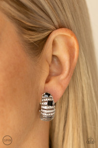Dotted with a pair of black rhinestones, row after row of white rhinestone encrusted bars fade into a stacked silver frame for a refined flair. Earring attaches to a standard clip-on fitting.
Sold as one pair of clip-on earrings. Dotted with a pair of black rhinestones, row after row of white rhinestone encrusted bars fade into a stacked silver frame for a refined flair. Earring attaches to a standard clip-on fitting.
Sold as one pair of clip-on earrings.