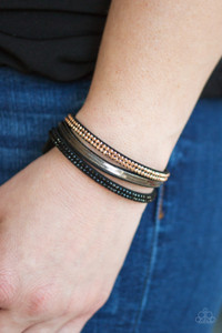 A brown suede band is spliced into three strands featuring rows of glittery hematite rhinestones, flat brass chain, and faceted metallic rhinestones for a glamorous look. Features an adjustable snap closure.
Sold as one individual bracelet. A brown suede band is spliced into three strands featuring rows of glittery hematite rhinestones, flat brass chain, and faceted metallic rhinestones for a glamorous look. Features an adjustable snap closure.
Sold as one individual bracelet.