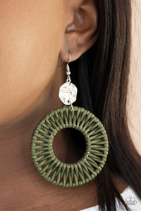 Green twine-like cording weaves around two silver rings, creating a woven hoop at the bottom of a hammered silver disc. Earring attaches to a standard fishhook fitting.
Sold as one pair of earrings. Green twine-like cording weaves around two silver rings, creating a woven hoop at the bottom of a hammered silver disc. Earring attaches to a standard fishhook fitting.
Sold as one pair of earrings.
