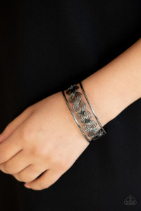 Flattened in sections, rows of glistening gunmetal wire weave between two gunmetal bars, creating a shimmery cuff around the wrist.
Sold as one individual bracelet. Flattened in sections, rows of glistening gunmetal wire weave between two gunmetal bars, creating a shimmery cuff around the wrist.
Sold as one individual bracelet.