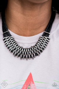 Bold and unapologetic, this hefty necklace gives off a hand-made feel with its multiple strands of black cording held together by industrial silver fittings that shift and slide. Features an adjustable clasp closure.

Sold as one individual necklace. Includes one pair of matching earrings.