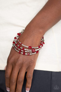 Varying in size and shape, red crystal-like beads and glistening silver beads are threaded along a coiled wire, creating a regal infinity wrap style bracelet around the wrist. Sold as one individual bracelet. Varying in size and shape, red crystal-like beads and glistening silver beads are threaded along a coiled wire, creating a regal infinity wrap style bracelet around the wrist. Sold as one individual bracelet.