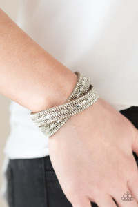 Featuring round and emerald style cuts, glassy white rhinestones are encrusted along a tan suede band. Rows of shimmery silver ball-chain are pressed into the glittery band for a sassy finish. The elongated band allows for a trendy double wrap design. Features an adjustable snap closure.

Sold as one individual bracelet.