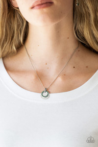 A glistening silver disc and a green rhinestone encrusted ring slide along a sleek silver chain, coalescing into a refined pendant below the collar. Features an adjustable clasp closure.
Sold as one individual necklace. Includes one pair of matching earrings. A glistening silver disc and a green rhinestone encrusted ring slide along a sleek silver chain, coalescing into a refined pendant below the collar. Features an adjustable clasp closure.
Sold as one individual necklace. Includes one pair of matching earrings.