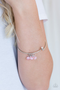 Glassy pink beads and glittery white rhinestones slide along a dainty silver wire infused with a rhinestone encrusted fitting, creating a versatile adjustable like bangle. Features a hinged closure.

Sold as one individual bracelet.