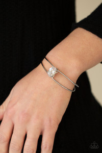 A dramatically oversized white rhinestone is fitted in place atop the center of a gunmetal wire cuff, creating a jaw-dropping display around the wrist.
Sold as one individual bracelet. A dramatically oversized white rhinestone is fitted in place atop the center of a gunmetal wire cuff, creating a jaw-dropping display around the wrist.
Sold as one individual bracelet.