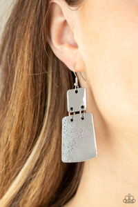 Stamped in an abstract pattern, a flared silver plate links to the bottom of a square silver frame, creating a rustic lure. Earring attaches to a standard fishhook fitting.

Sold as one pair of earrings.