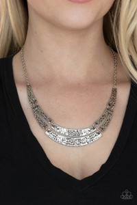 Featuring a high-sheen finish, abstract silver frames are embossed in gritty texture as they delicately link below the collar for a rustic display. Features an adjustable clasp closure.
Sold as one individual necklace. Includes one pair of matching earrings. Featuring a high-sheen finish, abstract silver frames are embossed in gritty texture as they delicately link below the collar for a rustic display. Features an adjustable clasp closure.
Sold as one individual necklace. Includes one pair of matching earrings.