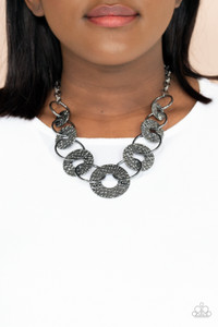 Gradually increasing in size near the center, a collection of glistening gunmetal rings and abstract hammered discs interlock below the collar for an intense industrial look. Features an adjustable clasp closure.
Sold as one individual necklace. Includes one pair of matching earrings. Gradually increasing in size near the center, a collection of glistening gunmetal rings and abstract hammered discs interlock below the collar for an intense industrial look. Features an adjustable clasp closure.
Sold as one individual necklace. Includes one pair of matching earrings.