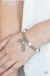 An earthy collection of hammered silver beads and round white stones are threaded along a stretchy band around the wrist. A dainty silver tassel, hammered silver disc, and a white stone swing from the seasonal display, adding playful movement to the whimsy look.
Sold as one individual bracelet. An earthy collection of hammered silver beads and round white stones are threaded along a stretchy band around the wrist. A dainty silver tassel, hammered silver disc, and a white stone swing from the seasonal display, adding playful movement to the whimsy look.
Sold as one individual bracelet.