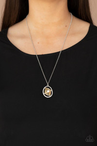 A raw cut topaz gem asymmetrically adorns the center of a warped white rhinestone oval frame, creating an extra sparkly pendant at the bottom of a classic silver frame. Features an adjustable clasp closure.
Sold as one individual necklace. Includes one pair of matching earrings. A raw cut topaz gem asymmetrically adorns the center of a warped white rhinestone oval frame, creating an extra sparkly pendant at the bottom of a classic silver frame. Features an adjustable clasp closure.
Sold as one individual necklace. Includes one pair of matching earrings.