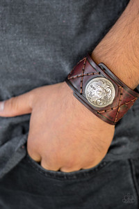 Featuring a flowery silver bead, a thick brown leather band has been stitched in diamond patterns across the front for a rugged look. Features an adjustable snap closure.
Sold as one individual bracelet. Featuring a flowery silver bead, a thick brown leather band has been stitched in diamond patterns across the front for a rugged look. Features an adjustable snap closure.
Sold as one individual bracelet.