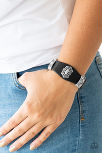 Infused with ornate metallic accents, an antiqued floral shaped frame is pressed into the center of a shiny black leather band for a rustic look. Features an adjustable snap closure.
Sold as one individual bracelet. Infused with ornate metallic accents, an antiqued floral shaped frame is pressed into the center of a shiny black leather band for a rustic look. Features an adjustable snap closure.
Sold as one individual bracelet.