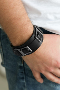 A collection of leather pieces and antiqued gunmetal frames are studded in place across the front of a thick leather band, creating an abstract buckle. Features an adjustable snap closure.
Sold as one individual bracelet. A collection of leather pieces and antiqued gunmetal frames are studded in place across the front of a thick leather band, creating an abstract buckle. Features an adjustable snap closure.
Sold as one individual bracelet.