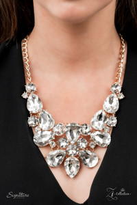 An elaborately exaggerated display of oversized round and teardrop white rhinestones classically coalesces into majestically mismatched golden frames. The dauntless dazzle delicately links below the collar, creating a stunning statement piece jampacked with unapologetic sparkle. Features an adjustable clasp closure.
Named after the 2021 Seize the Spotlight winner, Beatriz V.
Sold as one individual necklace. Includes one pair of matching earrings. An elaborately exaggerated display of oversized round and teardrop white rhinestones classically coalesces into majestically mismatched golden frames. The dauntless dazzle delicately links below the collar, creating a stunning statement piece jampacked with unapologetic sparkle. Features an adjustable clasp closure.
Named after the 2021 Seize the Spotlight winner, Beatriz V.
Sold as one individual necklace. Includes one pair of matching earrings.