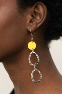 A pearly yellow shell disc anchors to two shiny hammered silver asymmetrical hoops as they dangle from the ear creating a dazzling lure. Earring attaches to a standard fishhook fitting.

Sold as one pair of earrings.